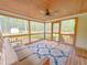 Screened-in porch with furniture and view of the trees in the yard at 122 American Rd, Timberlake, NC 27583