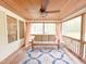 Comfortable screened-in porch with wooden ceiling, ceiling fan, cushioned seating, and outdoor view at 122 American Rd, Timberlake, NC 27583