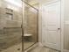 Bathroom shower featuring glass door, tile surround, and shower bench at 125 Claymore Dr, Clayton, NC 27527