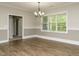 Open dining room area with hardwood flooring and chandelier lighting at 125 Claymore Dr, Clayton, NC 27527