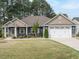 Charming single Gathering home with two-car garage and landscaped front yard at 125 Claymore Dr, Clayton, NC 27527