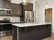 Kitchen boasts stainless appliances, dark cabinets, and light countertops at 125 Claymore Dr, Clayton, NC 27527
