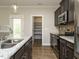 Kitchen with stainless appliances, dark cabinets, granite countertops, and a walk-in pantry at 125 Claymore Dr, Clayton, NC 27527
