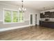 Bright kitchen features stainless appliances, dark cabinets, light countertops, and hardwood floors at 125 Claymore Dr, Clayton, NC 27527