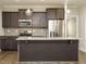Kitchen view featuring stainless steel appliances, dark cabinets, light countertops, and pendant lighting at 125 Claymore Dr, Clayton, NC 27527