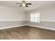 Open living room featuring hardwood flooring, neutral paint, and fan fixture at 125 Claymore Dr, Clayton, NC 27527