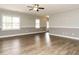 Open-plan living room featuring hardwood floors and neutral paint at 125 Claymore Dr, Clayton, NC 27527