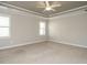 Large main bedroom with tray ceiling, carpeted floors, and natural light at 125 Claymore Dr, Clayton, NC 27527
