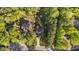 Aerial view of a home with lush green surroundings, long driveway, and a meticulously maintained yard at 128 Waterleaf Pl, Clayton, NC 27527