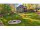 Expansive backyard featuring a fire pit area, ideal for outdoor entertaining and enjoying nature's beauty at 128 Waterleaf Pl, Clayton, NC 27527
