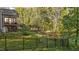 Fenced backyard with mature trees creating a private, natural backdrop at 128 Waterleaf Pl, Clayton, NC 27527