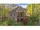 Backyard view of a two-story house with a deck overlooking a well-maintained lawn at 128 Waterleaf Pl, Clayton, NC 27527