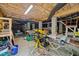 Unfinished basement space featuring visible beams and utilities, perfect for workshop or storage at 128 Waterleaf Pl, Clayton, NC 27527