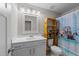 Bathroom featuring a vanity with storage and a tub with decorative shower curtain at 128 Waterleaf Pl, Clayton, NC 27527