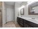 Bathroom with a double sink vanity with dark cabinets and a tiled floor at 128 Waterleaf Pl, Clayton, NC 27527