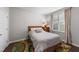 Cozy bedroom with wood floors, area rug, window and neutral colored decor at 128 Waterleaf Pl, Clayton, NC 27527