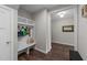 Charming entryway with built-in shelving, bench, and hooks for organization, enhanced by wood flooring at 128 Waterleaf Pl, Clayton, NC 27527