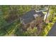 Aerial showcases the home's architectural design and landscaped surroundings in a tranquil setting at 128 Waterleaf Pl, Clayton, NC 27527