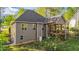 Exterior view highlighting the home's siding, windows, and a cozy covered deck for relaxation at 128 Waterleaf Pl, Clayton, NC 27527