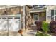 Close-up view of home featuring well-kept landscaping and two-car garage at 128 Waterleaf Pl, Clayton, NC 27527