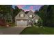 Charming two-story home with a well-manicured lawn and attached two-car garage at 128 Waterleaf Pl, Clayton, NC 27527