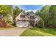 Charming two-story home with a well-manicured lawn and attached two-car garage at 128 Waterleaf Pl, Clayton, NC 27527