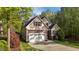 Charming home featuring a two-car garage, manicured lawn, and tasteful landscaping at 128 Waterleaf Pl, Clayton, NC 27527
