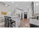 Modern kitchen with white cabinets, stainless steel appliances, and bar seating at 128 Waterleaf Pl, Clayton, NC 27527