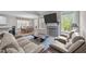 Open-concept living room with fireplace, adjacent to dining area, providing a spacious layout at 128 Waterleaf Pl, Clayton, NC 27527