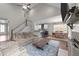 Spacious living room with stairs, connecting living, dining, and kitchen areas seamlessly at 128 Waterleaf Pl, Clayton, NC 27527
