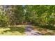 A peaceful walking path amidst lush greenery and tall trees at 128 Waterleaf Pl, Clayton, NC 27527