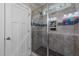 Modern tiled shower with glass door, rainfall showerhead, and built-in niche at 128 Waterleaf Pl, Clayton, NC 27527