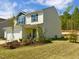 Two-story home with white siding, blue accents, landscaping, and a well-maintained lawn against a sunny blue sky at 135 Shallow Dr, Youngsville, NC 27596