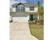 Charming two-story home with white siding, blue accents, well maintained lawn and attached two car garage at 135 Shallow Dr, Youngsville, NC 27596