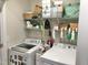 Well-organized laundry room with modern appliances, storage shelves, and ample space at 135 Shallow Dr, Youngsville, NC 27596