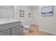 Bathroom with a single vanity, toilet, and decorative wall art at 1368 Ohio Ln, Sanford, NC 27332