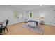 Bright basement bedroom with a full size bed, desk, and a door to the outside at 1368 Ohio Ln, Sanford, NC 27332