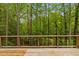 Wood deck featuring a wood and metal wire railing overlooking the forest behind the home at 1368 Ohio Ln, Sanford, NC 27332