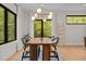 Bright dining room featuring modern lighting, large windows, and a wooden table with chairs at 1368 Ohio Ln, Sanford, NC 27332