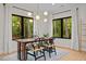 Bright dining room featuring modern lighting, large windows, and a wooden table with chairs at 1368 Ohio Ln, Sanford, NC 27332