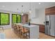 Well-lit kitchen with center island, pendant lights, and a modern aesthetic overlooking the outdoor landscape at 1368 Ohio Ln, Sanford, NC 27332