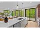Open kitchen design with island, stainless steel appliances, and views of the backyard deck at 1368 Ohio Ln, Sanford, NC 27332