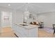 Open kitchen and living room area with a white kitchen island and pendant lighting at 1368 Ohio Ln, Sanford, NC 27332