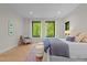 Bright main bedroom with views of wooded landscape, stylish decor, and a comfortable seating area at 1368 Ohio Ln, Sanford, NC 27332