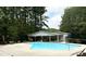 Sparkling community pool surrounded by lush greenery and a covered picnic area at 1368 Ohio Ln, Sanford, NC 27332