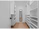 Spacious walk-in closet with custom shelving, drawers, and ample storage space, perfect for organization at 1368 Ohio Ln, Sanford, NC 27332