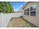Fenced backyard with a patch of grass, landscaping beds, and view of the house's exterior at 140 Torrey Heights Ln, Durham, NC 27703