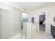 Bathroom with a glass-enclosed shower, separate tub, and neutral tile finishes at 140 Torrey Heights Ln, Durham, NC 27703