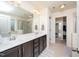 Bathroom with a double vanity, large mirror, and a view of the bathtub and shower at 140 Torrey Heights Ln, Durham, NC 27703
