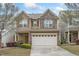 Charming two-story home with a two car garage, stone accents, and well maintained landscaping at 140 Torrey Heights Ln, Durham, NC 27703